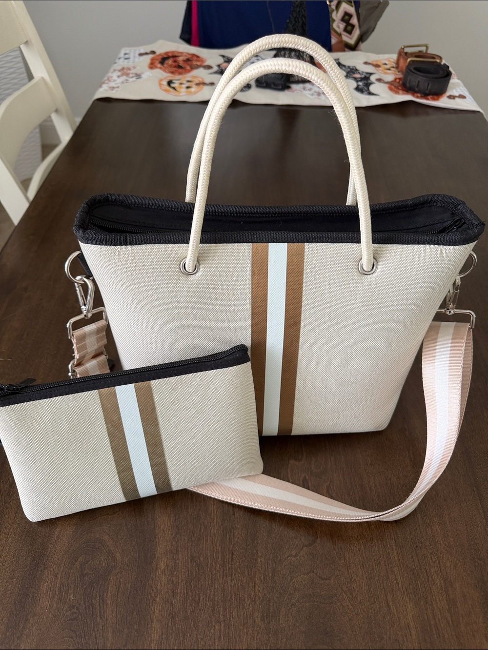 HAUTE SHORE Cream Tote with gold and white stripe. Includes matching wristlet.